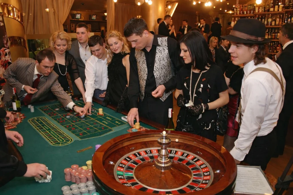 Casino Mottoparty mit Gästen am Roulettetisch bei einer stilvollen Abendveranstaltung
