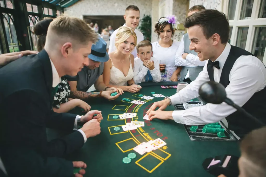 Casino Motto Hochzeit mit Gästen am Blackjack Tisch und Croupier in eleganter Atmosphäre