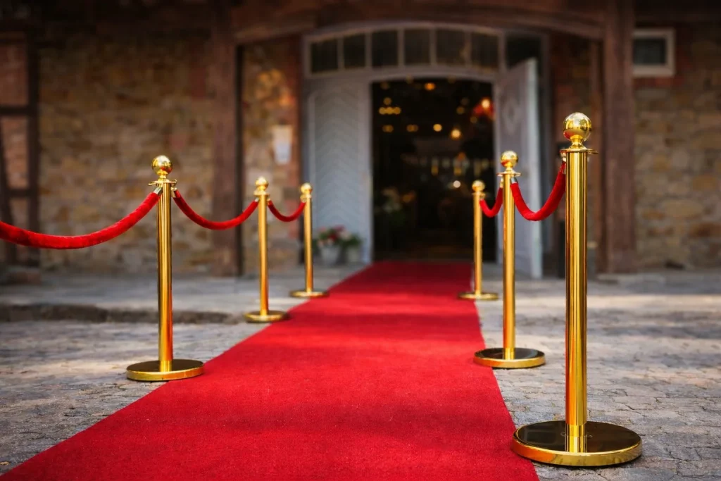 Roter Teppich mit goldenen Absperrpfosten für stilvollen Event-Empfang